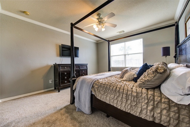 carpeted bedroom with ceiling fan, ornamental molding, and a textured ceiling