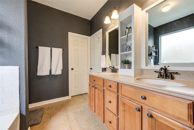 bathroom featuring tile patterned flooring, vanity, and a washtub