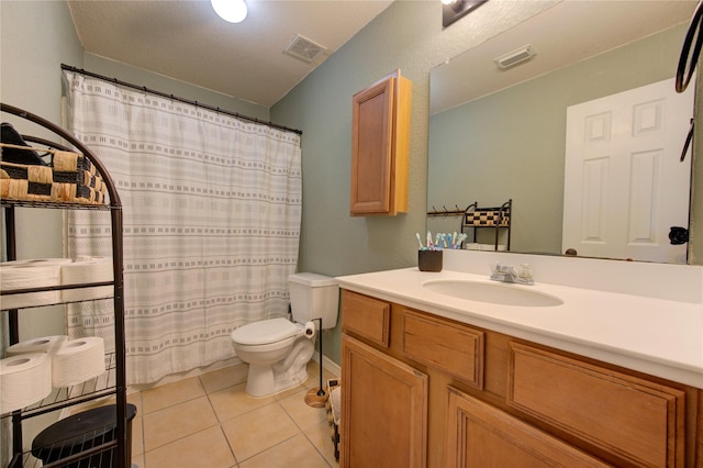 bathroom featuring tile patterned flooring, vanity, and toilet