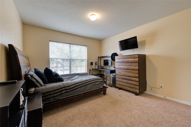 bedroom featuring carpet flooring and a textured ceiling