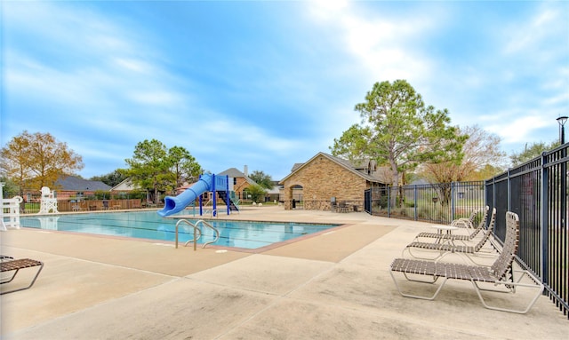 view of pool with a patio area and a water slide