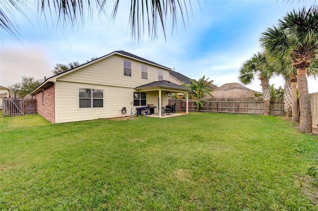 rear view of house with a yard and a patio