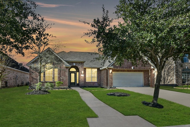 view of front of home featuring a yard and a garage