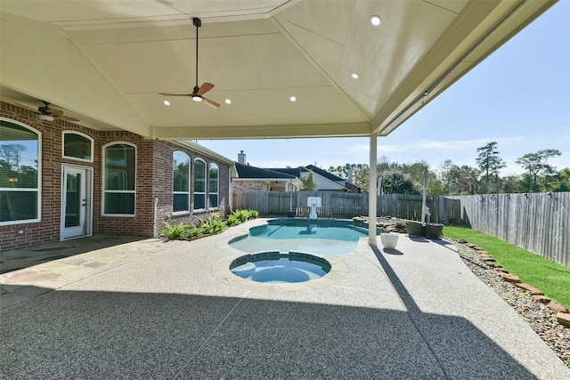 view of pool with ceiling fan, a patio, and an in ground hot tub