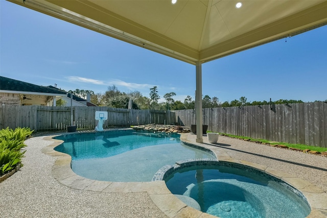 view of pool with an in ground hot tub