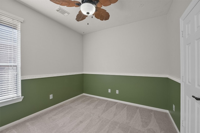 carpeted spare room with ceiling fan and a healthy amount of sunlight