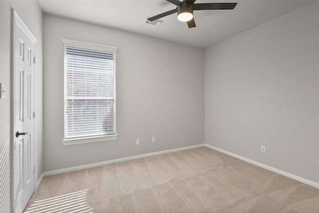 empty room featuring light carpet and ceiling fan