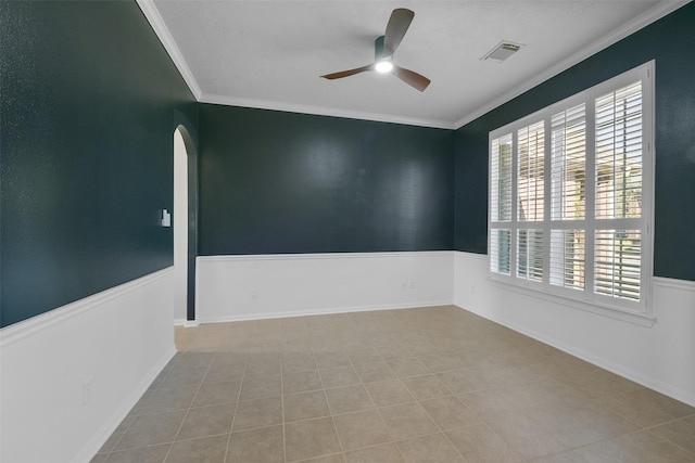 unfurnished room featuring ceiling fan, light tile patterned floors, and crown molding