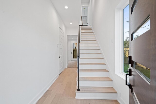 stairs featuring hardwood / wood-style floors