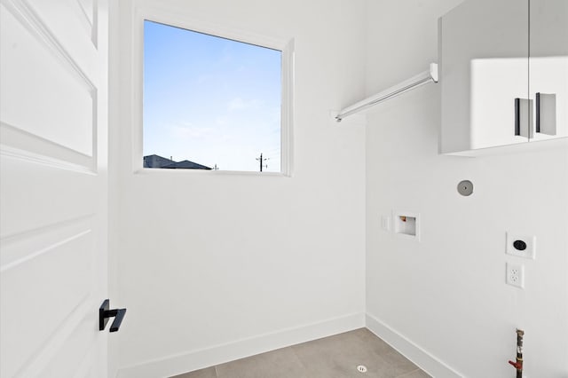 clothes washing area with hookup for a washing machine, light tile patterned floors, and hookup for an electric dryer