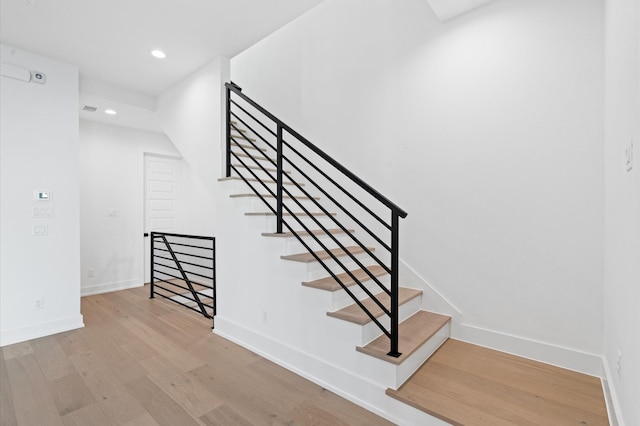 staircase featuring wood-type flooring