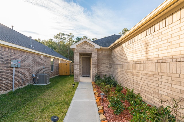 property entrance with central air condition unit and a yard