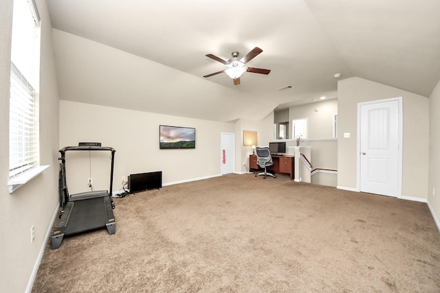 exercise room with carpet flooring, vaulted ceiling, and ceiling fan