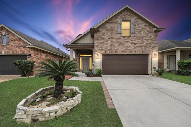 view of front property with a yard and a garage