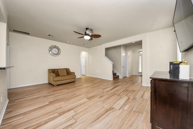 sitting room with ceiling fan and light hardwood / wood-style floors