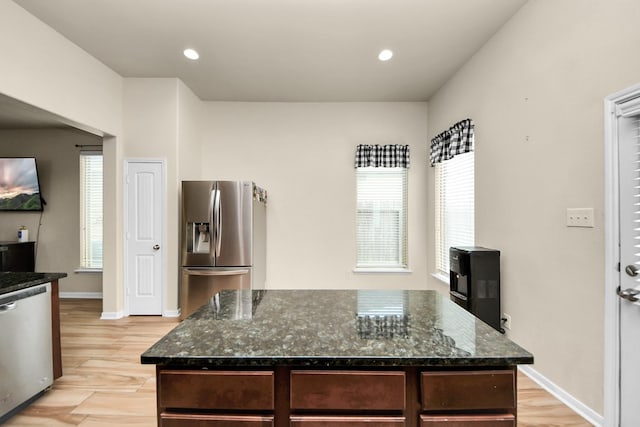 kitchen featuring a center island, dark stone countertops, and appliances with stainless steel finishes