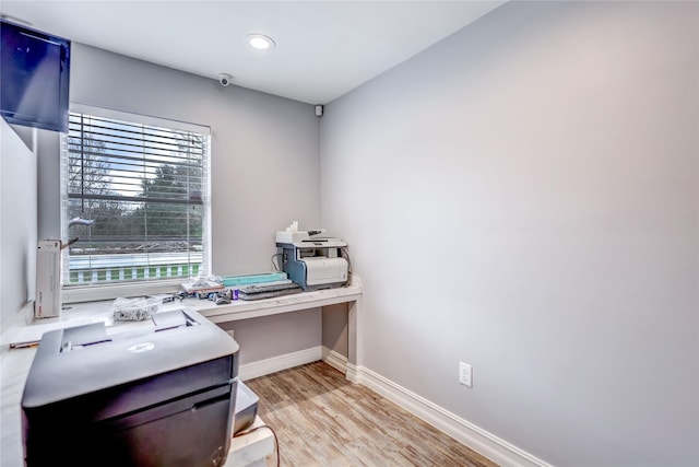 home office with light hardwood / wood-style floors