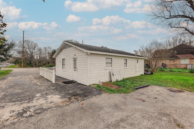 view of side of home featuring a lawn