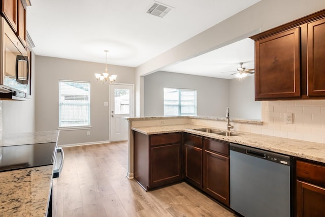 kitchen featuring sink, light hardwood / wood-style flooring, ceiling fan with notable chandelier, and appliances with stainless steel finishes