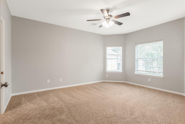 spare room with ceiling fan and carpet