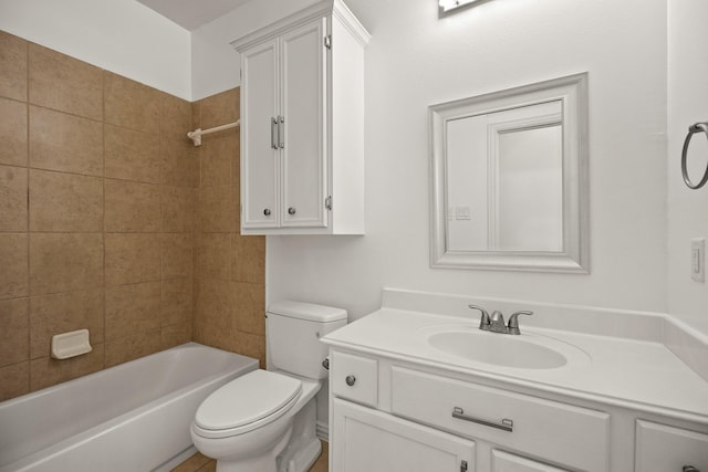 full bathroom with vanity, tiled shower / bath combo, and toilet