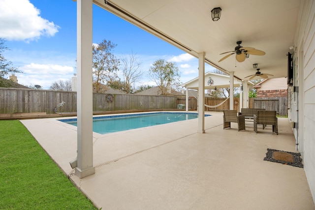 view of swimming pool featuring a patio area and ceiling fan