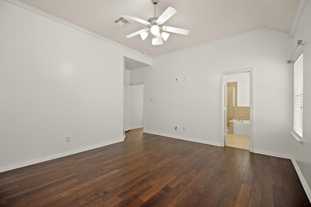 unfurnished bedroom featuring ceiling fan, dark wood-type flooring, ensuite bathroom, and ornamental molding