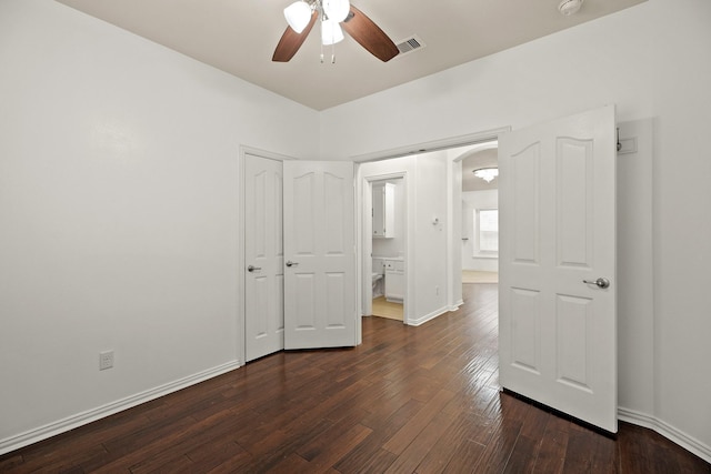 unfurnished bedroom featuring ceiling fan and dark wood-type flooring