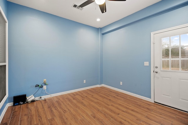 spare room featuring hardwood / wood-style flooring and ceiling fan