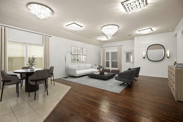 living room featuring a notable chandelier and wood-type flooring