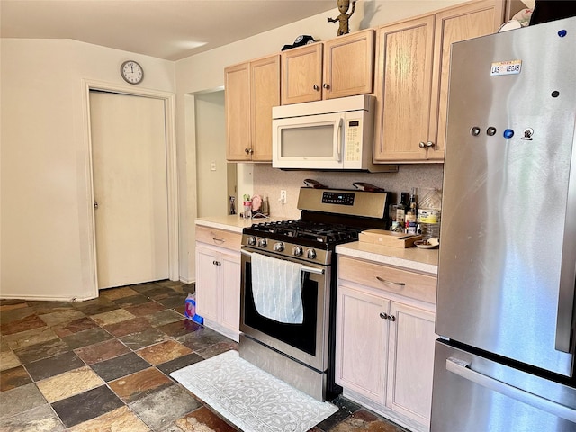 kitchen with light brown cabinets and appliances with stainless steel finishes