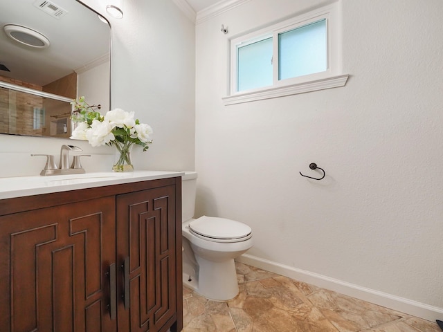 bathroom with toilet, vanity, a shower with door, and ornamental molding