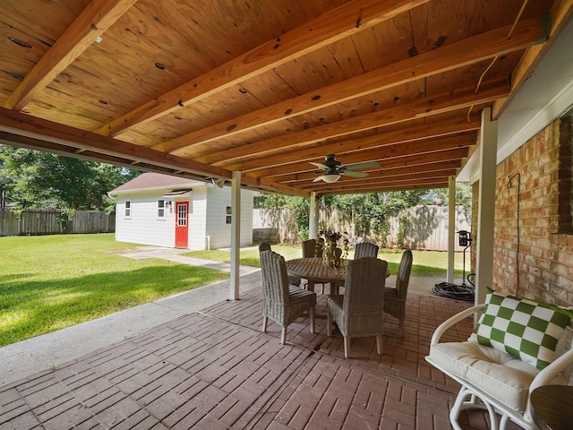 wooden deck with a yard, an outbuilding, and a patio