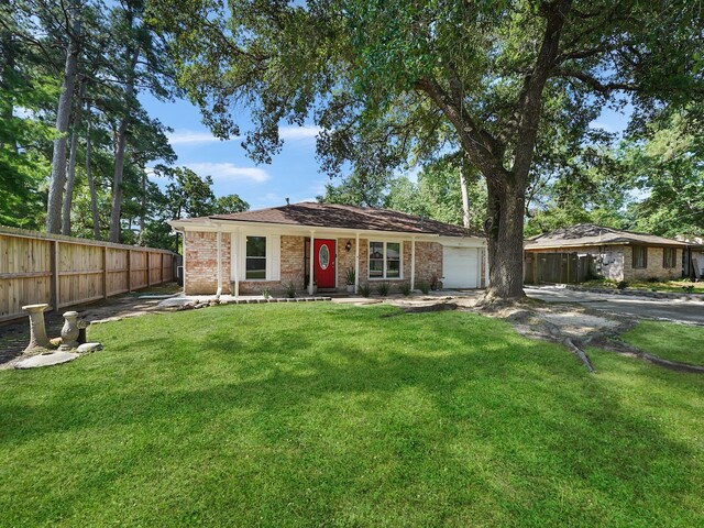 ranch-style house with a front yard and a garage