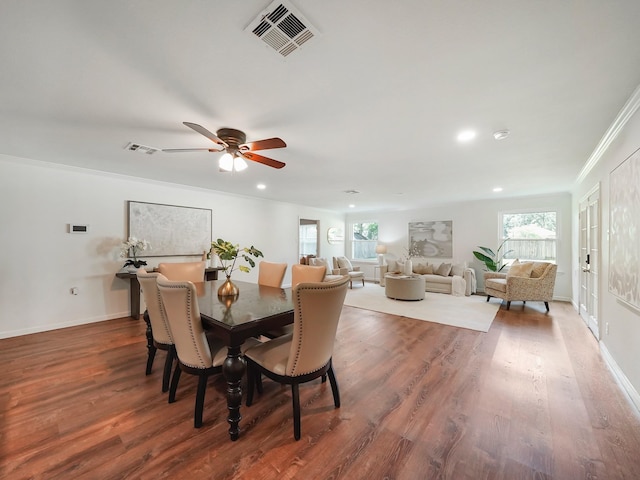 dining space featuring ceiling fan, french doors, dark hardwood / wood-style floors, and ornamental molding