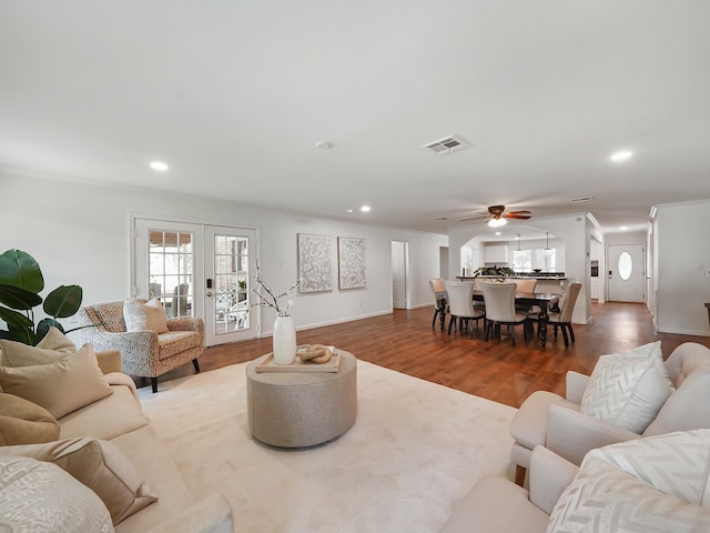 living room with french doors, hardwood / wood-style flooring, and ceiling fan