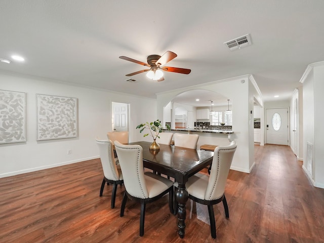 dining room featuring crown molding, ceiling fan, and dark hardwood / wood-style floors