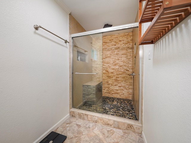 bathroom with crown molding and a shower with door