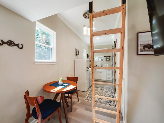 interior space featuring crown molding and light hardwood / wood-style flooring