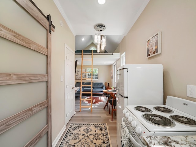 kitchen with white appliances, crown molding, hanging light fixtures, hardwood / wood-style flooring, and a barn door