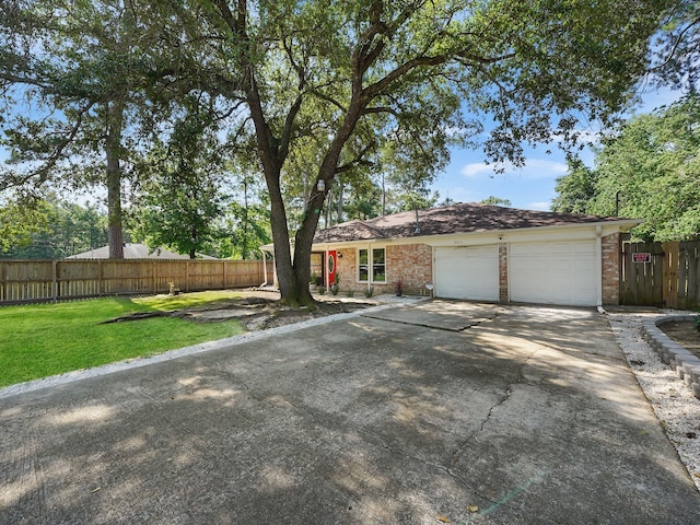 ranch-style home featuring a front lawn and a garage