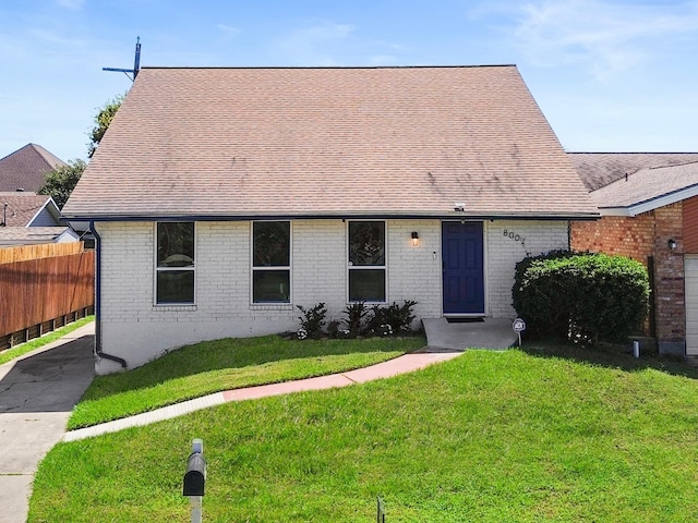 ranch-style house featuring a front lawn