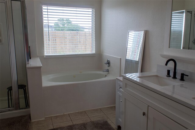 bathroom featuring tile patterned floors, separate shower and tub, and vanity