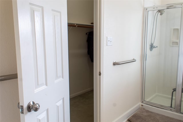 bathroom with a shower with shower door