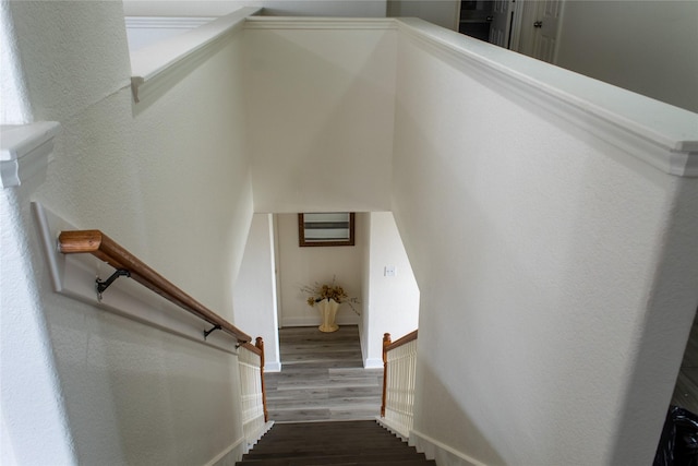 stairway with hardwood / wood-style flooring