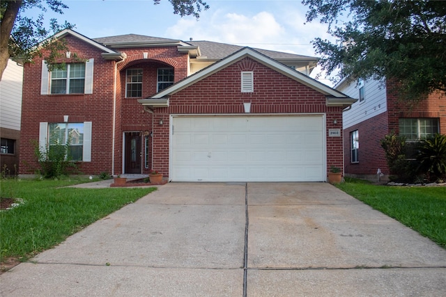 view of front property featuring a front yard and a garage