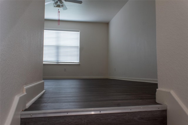 stairs with wood-type flooring and ceiling fan