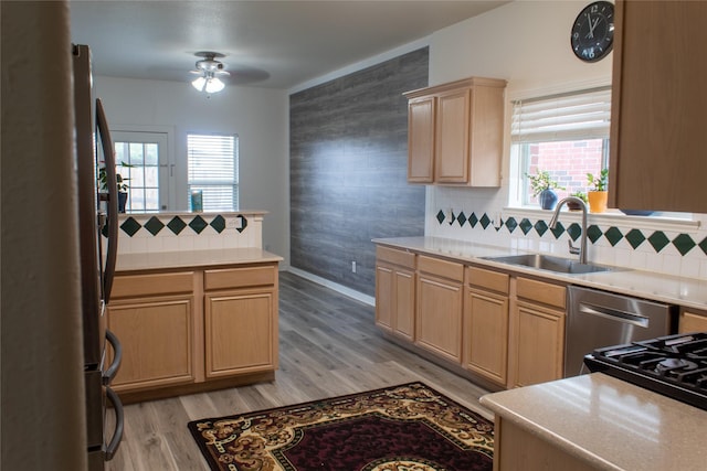 kitchen with ceiling fan, sink, light brown cabinets, tasteful backsplash, and light hardwood / wood-style floors