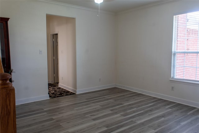 empty room featuring dark hardwood / wood-style floors and ornamental molding