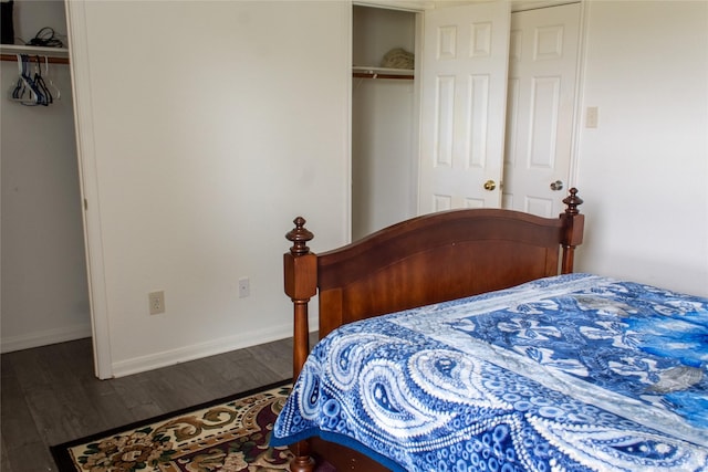 bedroom featuring dark hardwood / wood-style flooring and a closet